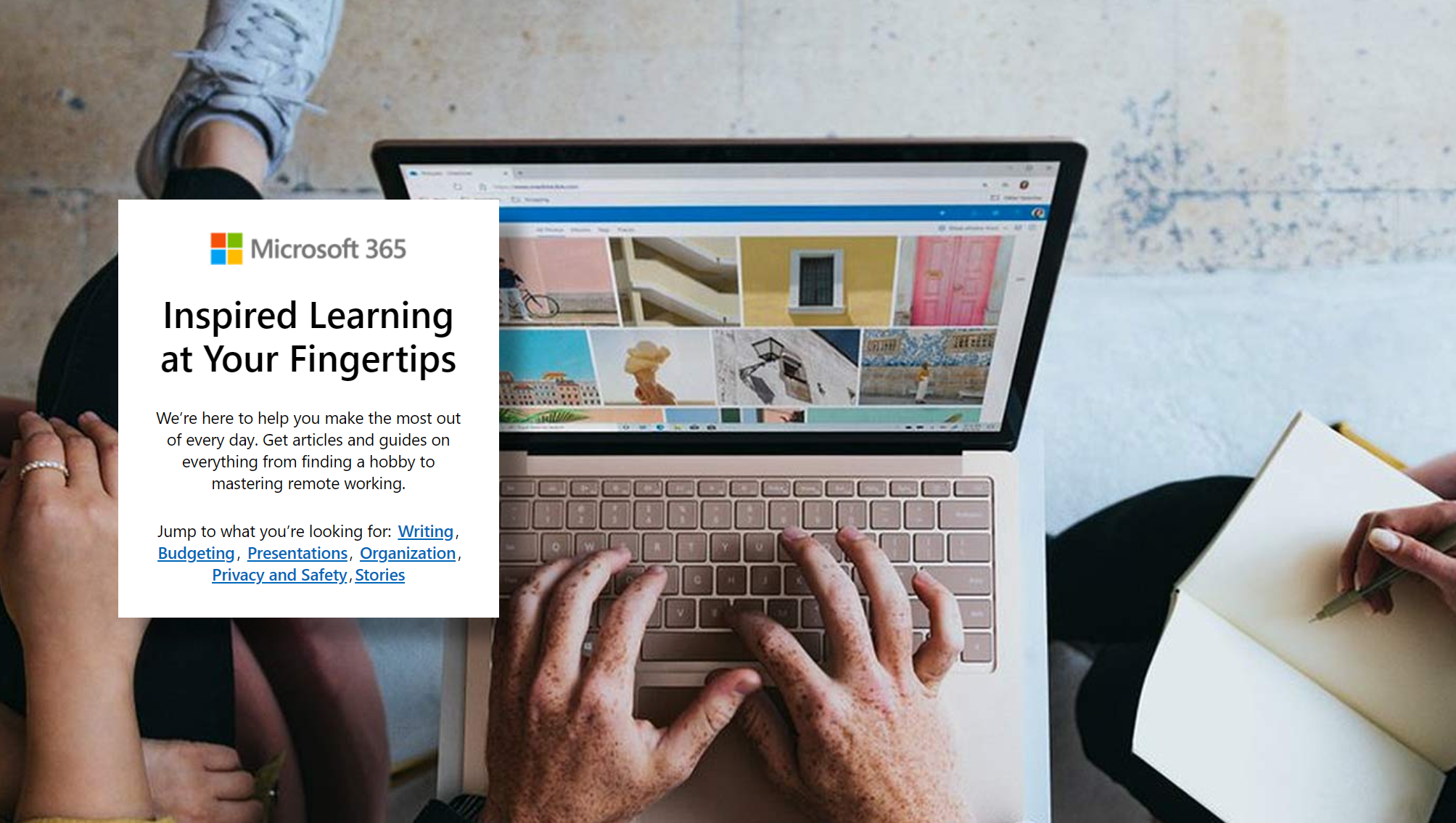 Three people focused on center laptop while taking notes.